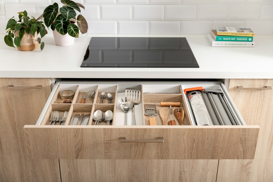 Open kitchen drawer with organized utensils