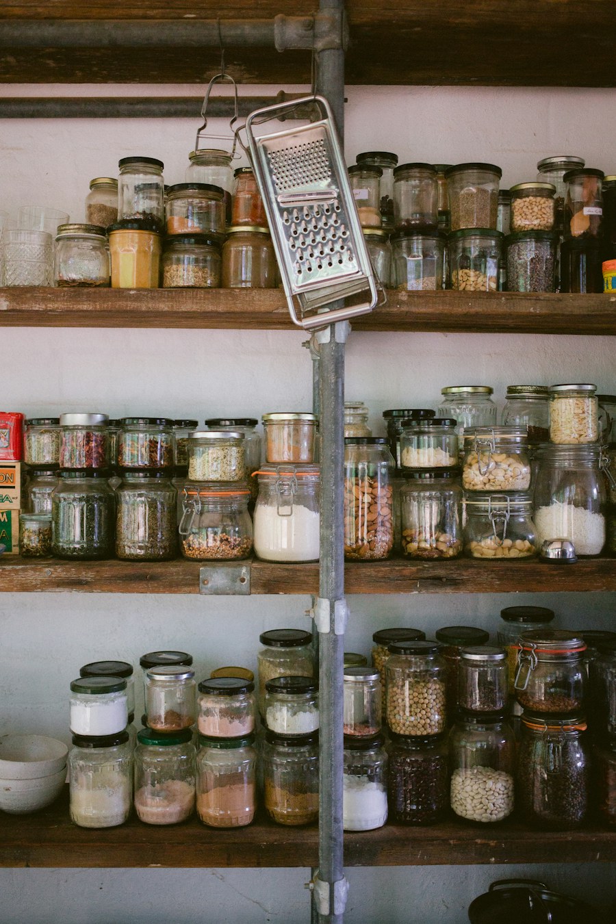 Glass storage jars arranged on a kitchen shelf